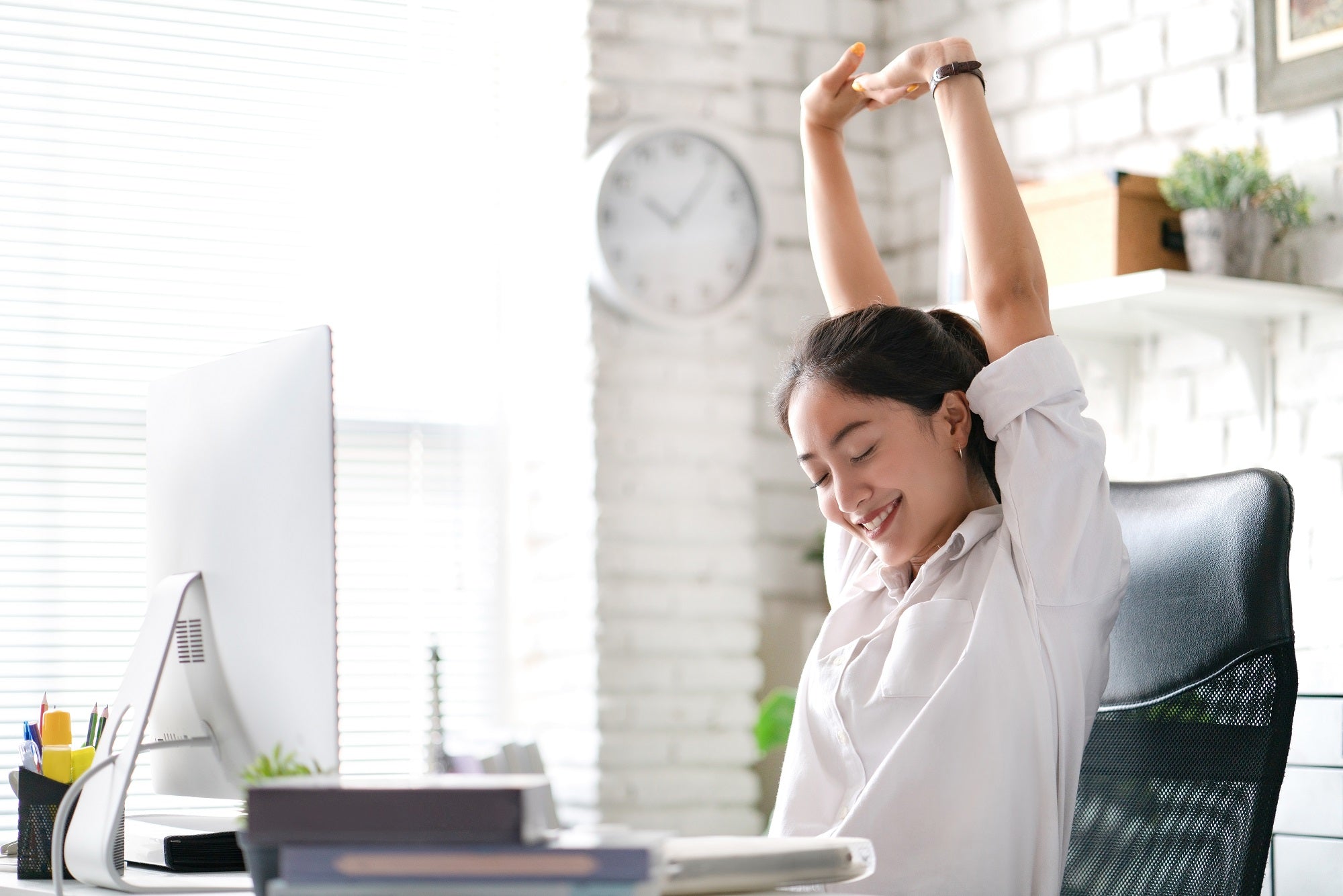 Businesswoman Relax from work stretching on the office chair